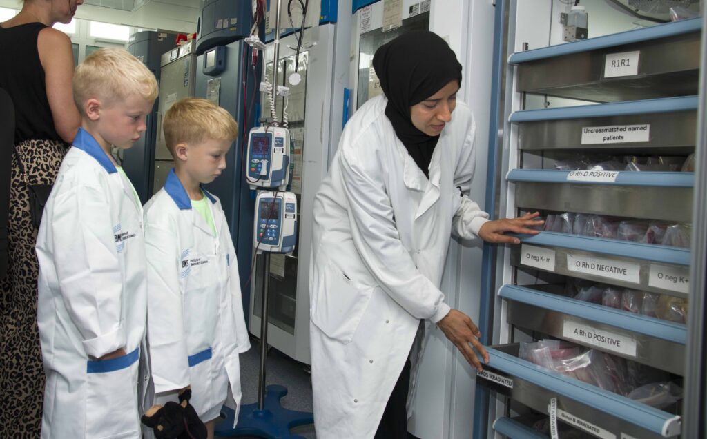 Image of Shazia Ismail giving a tour to siz year old Roco and his twin brother Frankie