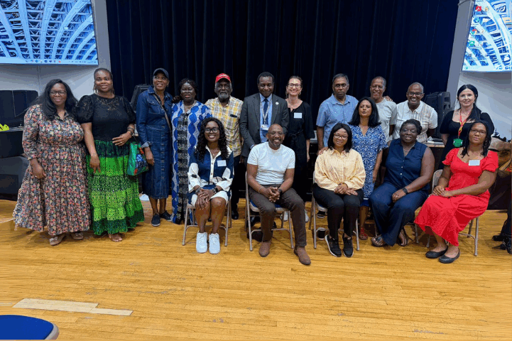 Colleagues in a community space for a group photo